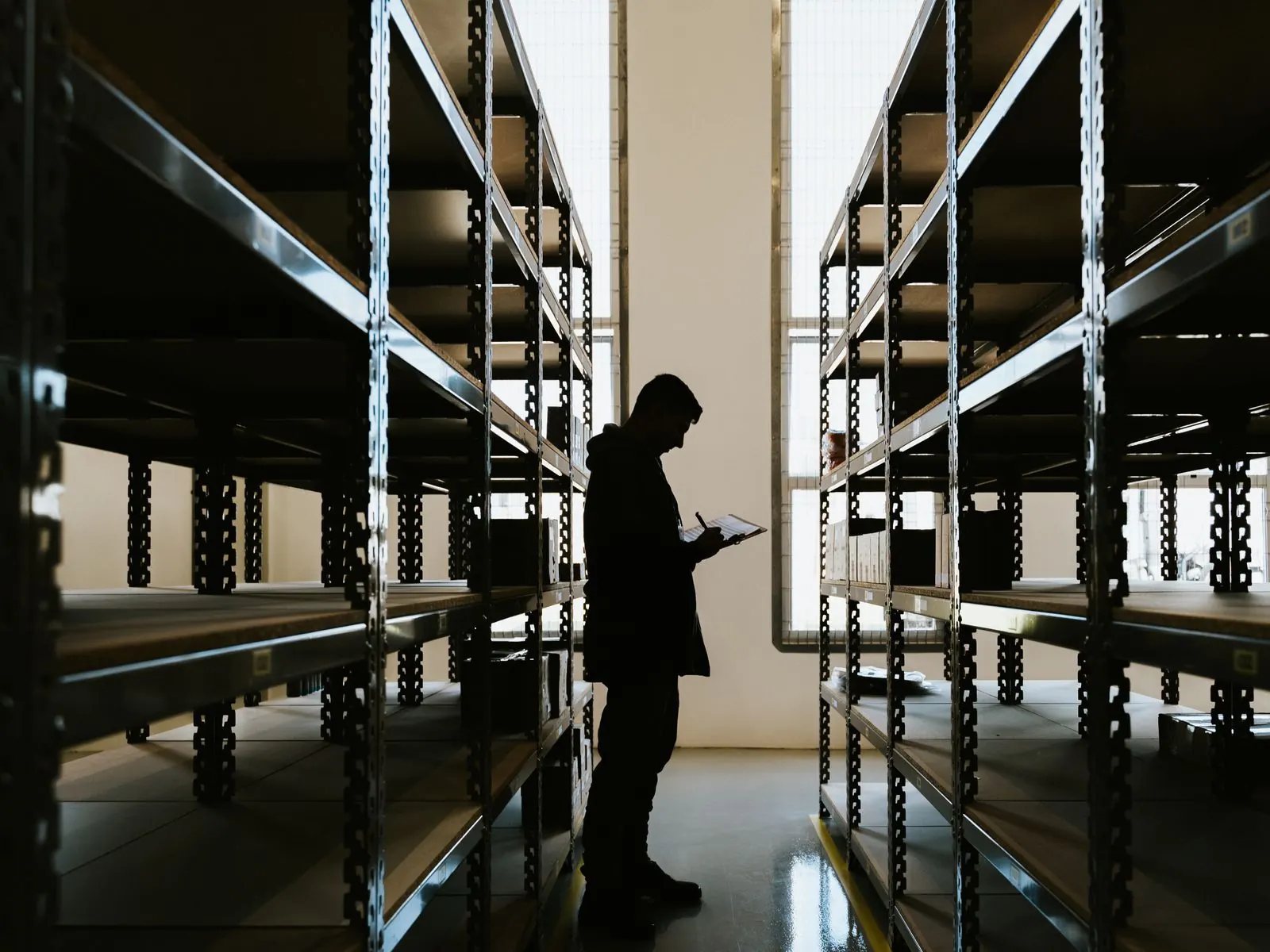 An Operations Engineer reviewing warehouse inventory during a discovery visit